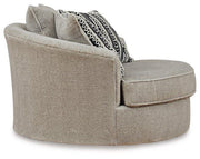 Ashley Furniture Calnita living room set with sofa and armchair, featuring neutral upholstery and wooden legs in a modern design.
