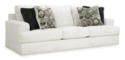 Ashley Furniture Karinne Sofa with plush gray upholstery and modern design, shown in a cozy living room setting.