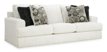 Ashley Furniture Karinne Sofa with plush gray upholstery and modern design, shown in a cozy living room setting.