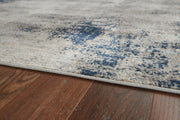 Ashley Furniture Wrenstow 7'10" x 10'3" rug featuring a stylish pattern and soft texture, ideal for living room or bedroom decor.