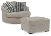 Ashley Furniture Calnita living room set with a sofa, armchair, and matching coffee table in a modern living space.