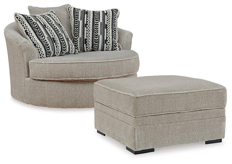 Ashley Furniture Calnita living room set with a sofa, armchair, and matching coffee table in a modern living space.
