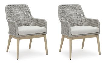Seton Creek outdoor seating set by Ashley Furniture featuring a sofa, chairs, and a table with cushions in a garden setting