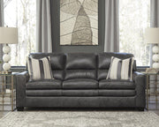 Ashley Furniture South 8x10 rug with intricate patterns in neutral tones, shown flat on the floor.