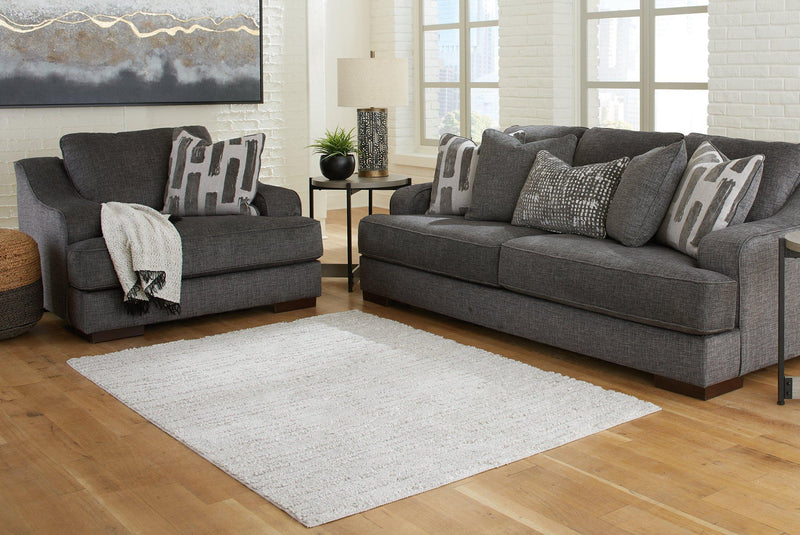 Ashley Furniture Ivygail 5x7 rug featuring a textured, woven design in neutral tones, perfect for living room or bedroom decor.