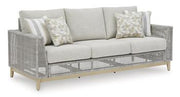 Ashley Furniture Seton Creek outdoor seating set with cushioned chairs and table, perfect for patio relaxation.
