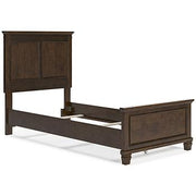 Ashley Furniture Danabrin Bed with a modern wooden frame and neutral-toned headboard in a bedroom setting