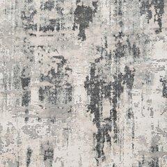 Ashley Furniture Mazatl 5'3" x 7'3" rug featuring a vibrant geometric pattern in earthy tones, suitable for living rooms or bedrooms.