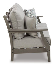 Ashley Furniture Visola outdoor seating set featuring a sofa, loveseat, and coffee table with weather-resistant cushions and stylish design.