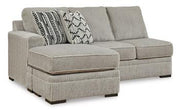 Ashley Furniture Calnita sectional with chaise, modern fabric sofa with plush cushions and a stylish design in a living room setting.