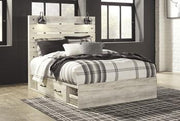 Ashley Furniture Cambeck bed with four spacious storage drawers, showcasing a stylish and functional bedroom centerpiece.