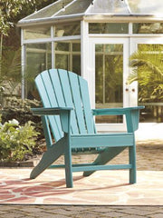 Outdoor table set by Ashley Furniture featuring a spacious table and matching chairs in a garden setting.