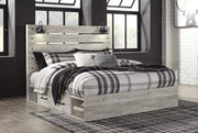 Ashley Furniture Cambeck bed with four storage drawers, featuring a sturdy frame and built-in storage for bedrooms.