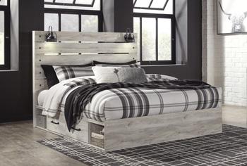 Ashley Furniture Cambeck bed with four storage drawers, featuring a sturdy frame and built-in storage for bedrooms.