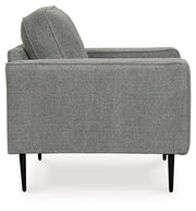 Ashley Hazela living room set with a sofa and armchair in a modern design, featuring neutral upholstery and wooden legs.