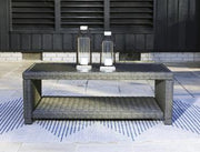 Outdoor table set by Ashley Furniture with two round tables and matching chairs, designed for outdoor use and casual gatherings.
