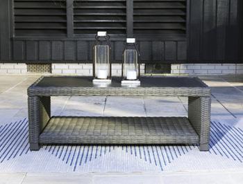 Outdoor table set by Ashley Furniture with two round tables and matching chairs, designed for outdoor use and casual gatherings.