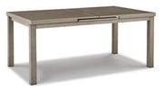 Outdoor dining set by Ashley Furniture with a table and chairs, designed for beachfront outdoor use in a scenic setting
