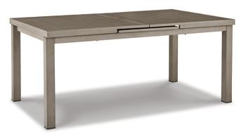 Outdoor dining set by Ashley Furniture with a table and chairs, designed for beachfront outdoor use in a scenic setting