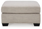 Ashley Furniture Mahoney oversized accent Ottoman with plush fabric, featuring a modern design and sturdy wooden legs.