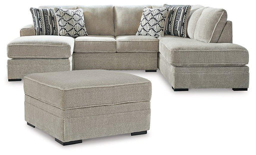 Ashley Furniture Calnita living room set featuring a sofa and loveseat with neutral upholstery and modern design.