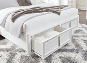 Ashley Furniture Chalanna upholstered storage bed with a padded headboard and built-in storage drawers in a modern bedroom setting