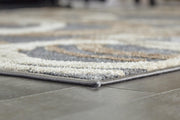 Ashley Furniture Faelyn 7'10" x 9'10" rug with intricate patterns and soft texture, ideal for living room or bedroom decor.
