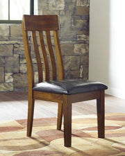 Ashley Ralene Dining Chair Set featuring upholstered seats and wooden legs, arranged around a dining table.