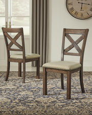 Ashley Furniture Moriville dining chair with upholstered seat and wooden legs, featuring a classic design.