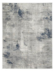 Wrenstow 7'10" x 10'3" rug by Ashley Furniture featuring a soft, patterned design in neutral tones on a hardwood floor.