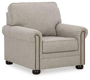 Ashley Gaelon Living Room Set featuring a sofa and armchair with neutral fabric upholstery and modern design elements.