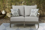 Ashley Furniture Visola outdoor loveseat conversation set with cushioned seats, wicker frames, and outdoor-friendly design.