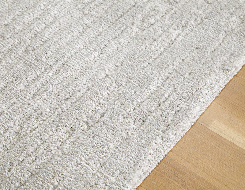 Ashley Furniture Ivygail 5x7 rug featuring a detailed floral pattern in neutral tones, perfect for living room or bedroom decor.