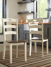 Set of two Woodanville dining chairs by Ashley Furniture with wood frames and upholstered seats, shown in a dining room setting.