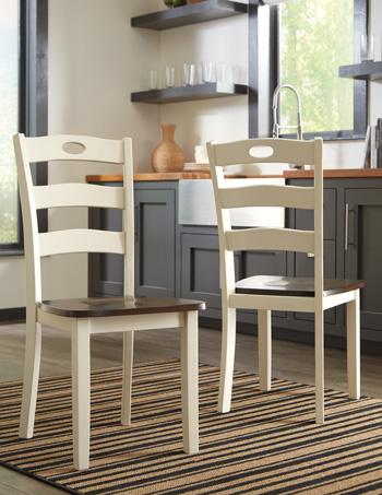 Set of two Woodanville dining chairs by Ashley Furniture with wood frames and upholstered seats, shown in a dining room setting.