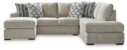 Ashley Furniture Calnita living room set featuring a sectional sofa with plush cushions and coordinating coffee table in a modern design.