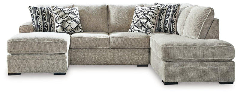 Ashley Furniture Calnita living room set featuring a sectional sofa with plush cushions and coordinating coffee table in a modern design.