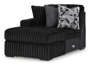 Midnight-Madness Ashley Furniture sectional sofa with plush cushions and chaise lounge in a dark fabric.