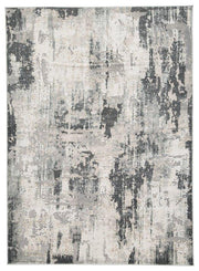 Ashley Furniture Mazatl 7'10" x 10'2" rug with intricate patterns and warm colors, displayed on a wooden floor.