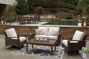 Outdoor Paradise Trail loveseat with cushion by Ashley Furniture, showcasing a stylish outdoor seating area with plush cushions.
