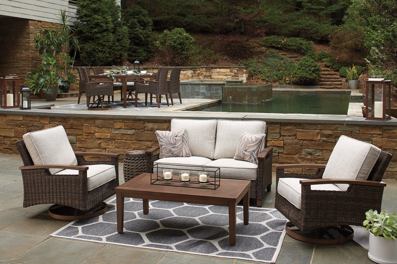 Outdoor Paradise Trail loveseat with cushion by Ashley Furniture, showcasing a stylish outdoor seating area with plush cushions.
