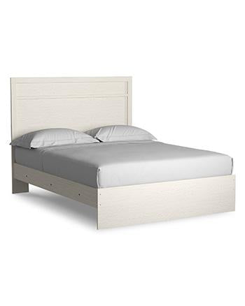 Ashley Furniture Stelsie bedroom set featuring a bed, dresser, and nightstands in a modern bedroom design.