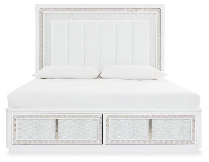 Upholstered storage bed by Ashley Furniture with a plush headboard and built-in storage drawers in a modern bedroom setting.