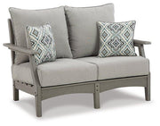 Outdoor Ashley Furniture Visola loveseat and coffee table set with cushioned seating and modern design for patio or garden.