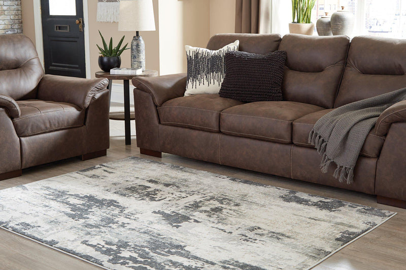 Ashley Furniture Mazatl 7'10" x 10'2" rug featuring intricate patterns and neutral colors, perfect for living room or bedroom decor.