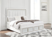 Ashley Furniture Chalanna upholstered storage bed with a neutral fabric headboard and built-in storage drawers in a modern bedroom setting.