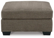Mahoney oversized accent ottoman by Ashley Furniture featuring plush fabric and a sturdy wooden base in a contemporary design.