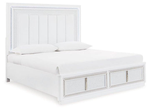 Ashley Furniture Chalanna upholstered storage bed with tufted headboard and built-in storage drawers in a modern bedroom setting.