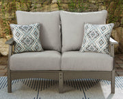 Outdoor seating set with Ashley Furniture loveseat and coffee table, featuring cushioned seats and a modern design for outdoor relaxation.