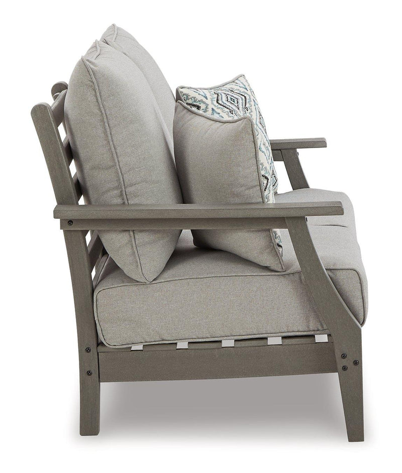 Outdoor loveseat conversation set by Ashley Furniture with cushioned seats and a coffee table, perfect for outdoor relaxation.